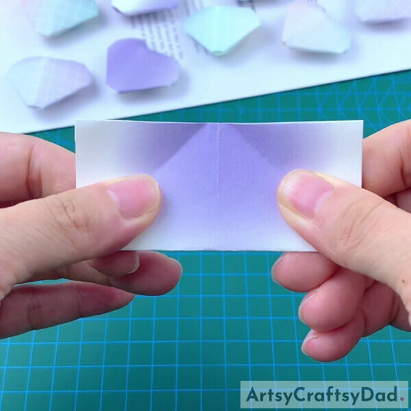 Folding Our Craft Paper Into Half Again- Guide to creating a paper heart origami for kids