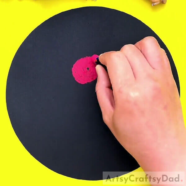 Making A Red Oval- An Artistic Representation of a Crayon Flower Garden on a Black Base
