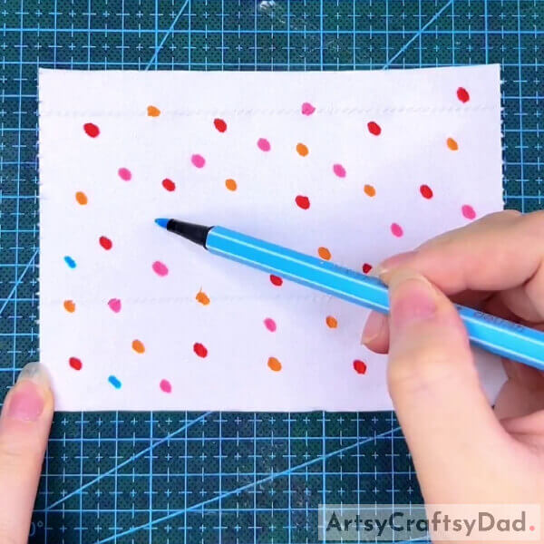 Making Sketch Pen Dots On The Tissue- How to Create a Colorful Butterfly with Tissue Paper and a Sketch Pen