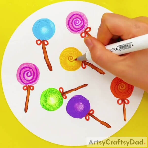 Making Spirals Over The Lollipop- Instructions for making a colorful lollipop stamp painting and drawing 