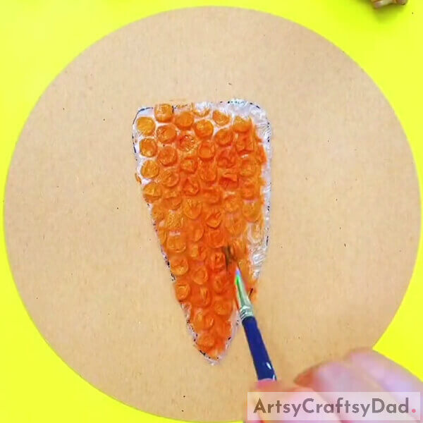 Painting The Carrot Cutout- How to Create a Craft with Bubble Wrap and Carrots for Kids