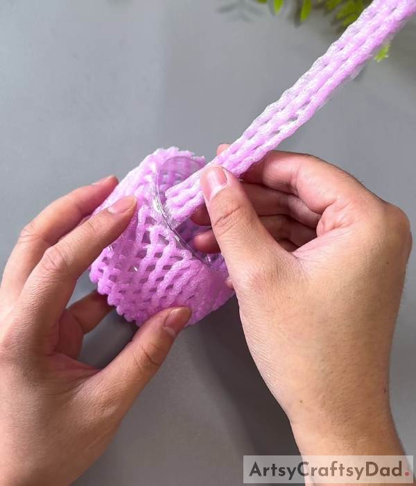 Pasting The Handle-Creating a basket out of reused materials such as foam netting and plastic bottles: A Guide 