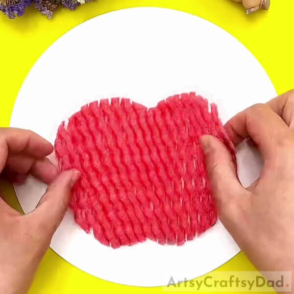 Pasting A Apple Shaped Fruit Foam Net-Fantastic Apple Fun Craft Using Fruit Foam Net For Kindergartners