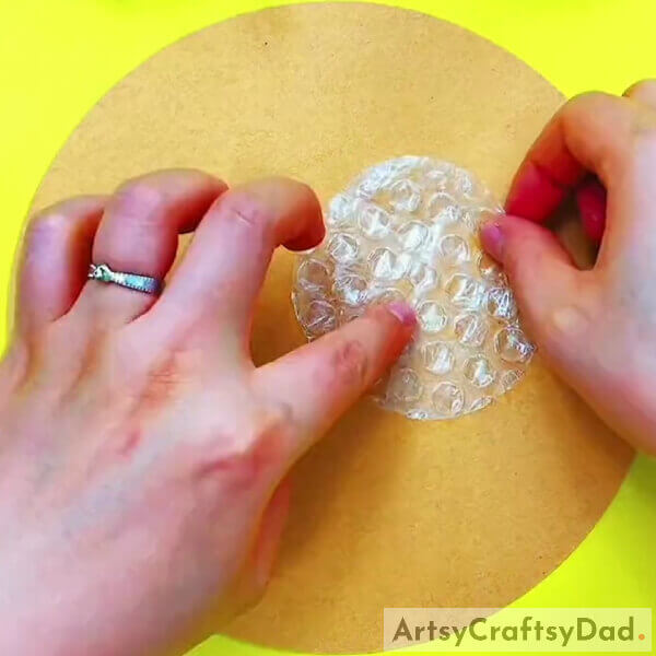 Pasting A Circle- Directions for making a pomegranate-themed artwork using bubble wrap