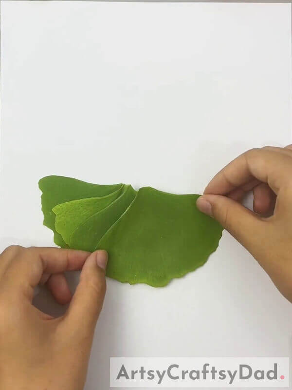Pasting A Few More Leaves On Craft Paper- How To Design A Stunning Dress Made Of Leaves For Children