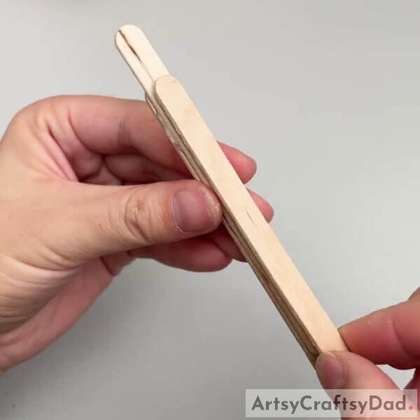 Pasting Another Popsicle Stick- Making a miniature plane from popsicle sticks