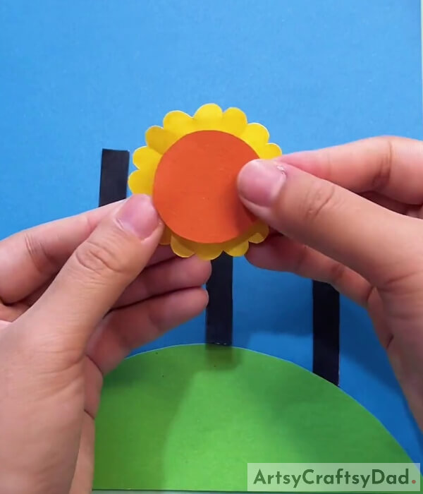 Pasting Circle Shaped Orange Cardstock Paper With Yellow Paper- Crafting a Sunflower Field on a Beautiful Day