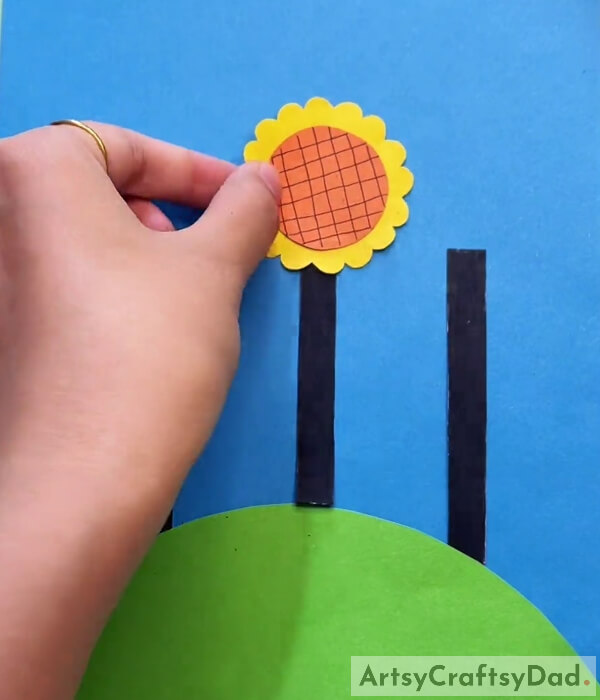 Pasting Flower With Black Strap- Creating Paper Art in a Sunflower Field on a Sunny Day