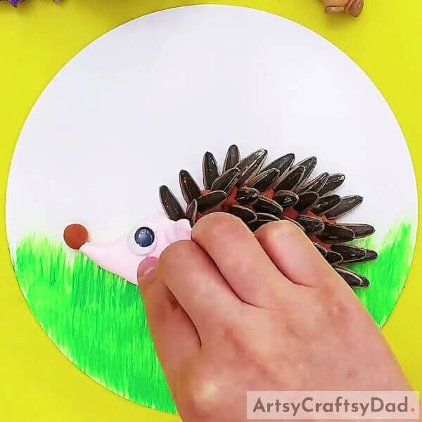 Pasting Googly Eyes- Crafting a Hedgehog with Sunflower Seeds & Clay - Tutorial