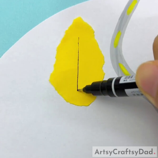 Pasting Piece Of Yellow Paper On White Craft Paper-Tutorial on constructing a paper ripping craft in a forest.