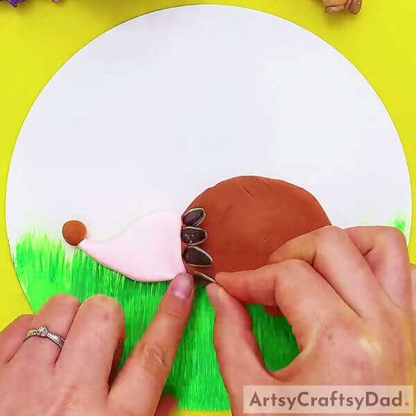 Pasting Sunflower Seeds Into Brown Clay- Tutorial: Crafting a Hedgehog Using Sunflower Seeds & Clay