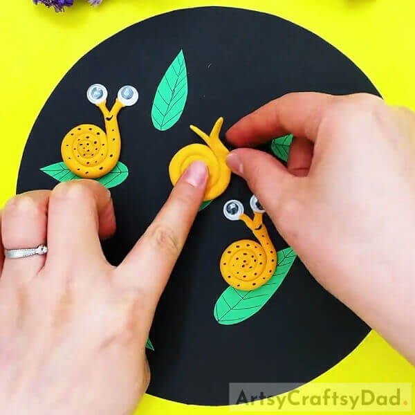 Sticking The Snail Over The Base-Amazing Clay Snails On Leaves Craft For Kids