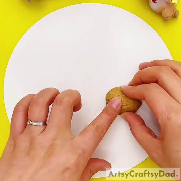 Sticking The Walnut Shell On Base- How to Make a Walnut Shell Reindeer with Children
