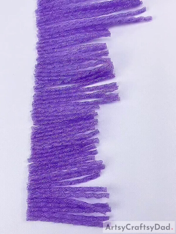 Complete pasting all the strands - Tutorial on Crafting an Artwork with Foam and Netting of Purple Fruit