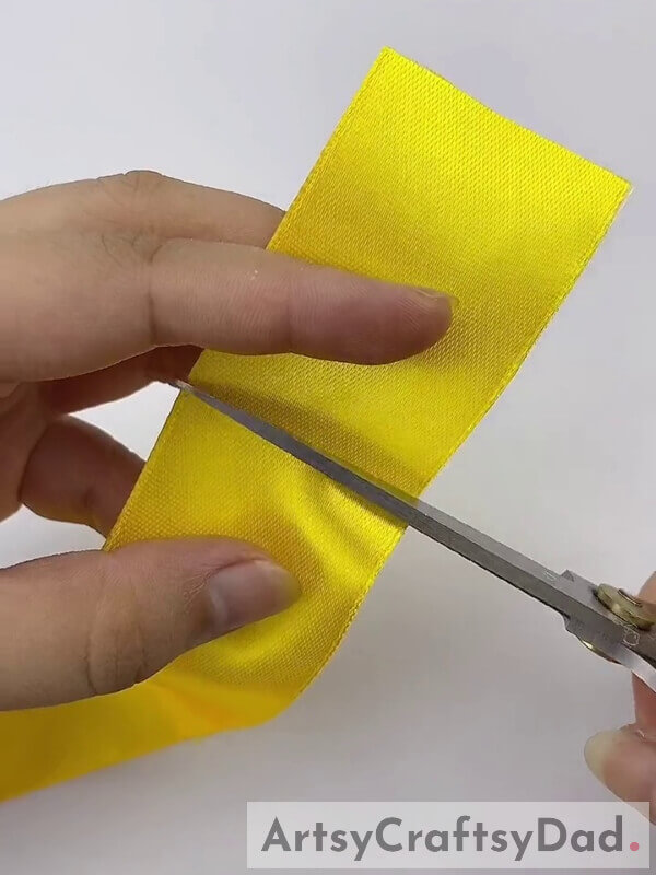 Cut Yellow Ribbon - Learn How to Add a Touch of Yellow-Orange Pampas Grass to Your Decoration with this Ribbon Craft Tutorial 