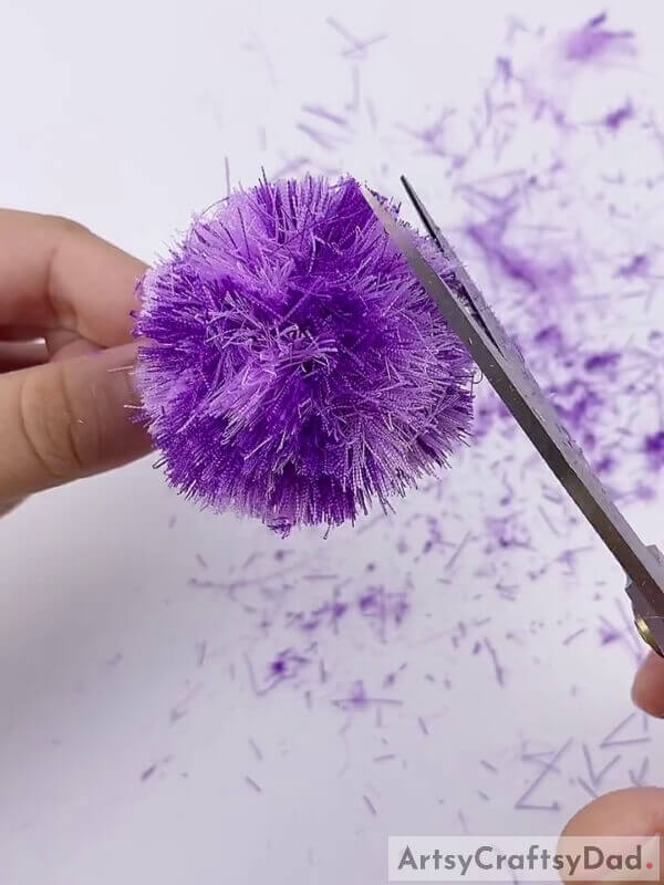 Cut out the extra length from the edges - A Fun Craft Tutorial for Kids: Ribbon Pom-Pom Flowers