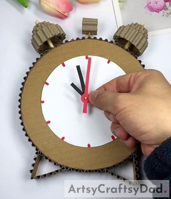 Fasten The Hands - Tutorial for kids on crafting a cardboard alarm clock model 