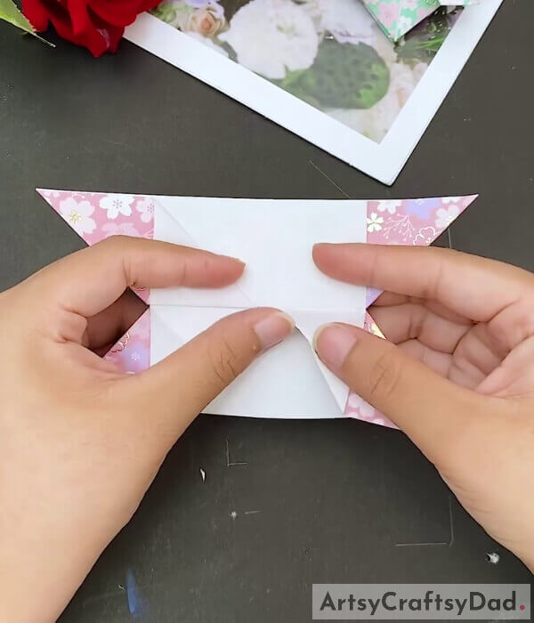 Flatten It - Youngsters can learn how to form a paper heart out of origami paper with this tutorial 