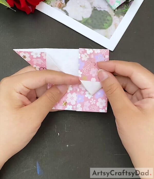 Fold The Upper Corners - This tutorial will show kids how to make a paper heart with origami paper 