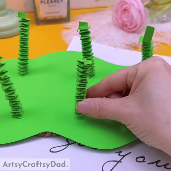 Make six similar patterns - Demonstrating a paper flower garden craft to children