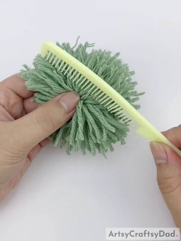 Now, brush the strands - Create a Pom-Pom Bouquet Using Wool Thread