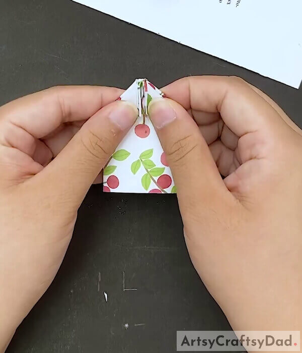 Open It - An instruction guide for creating an origami bow using paper for children 