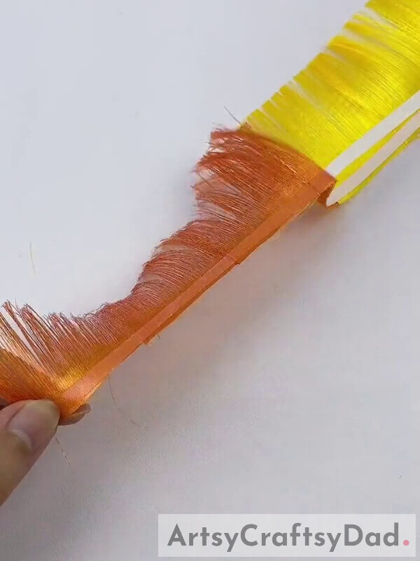 Remove the Double Side of the Tape - Step-by-Step Guide on How to Use Ribbon to Create a Yellow-Orange Pampas Grass Decoration 