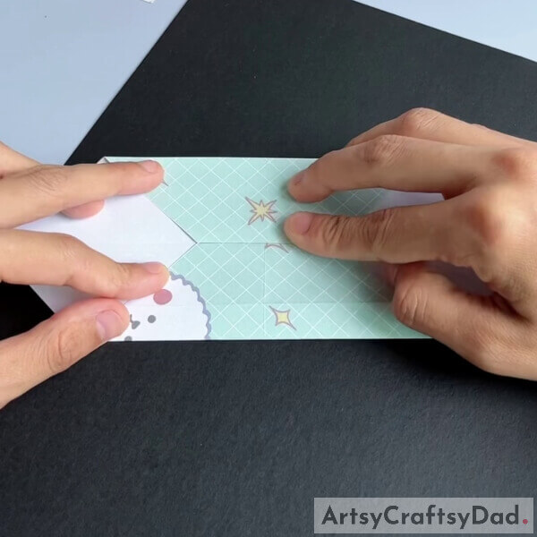 Repeat the same with the opposite side - Tutorial for youngsters on crafting a paper origami couch