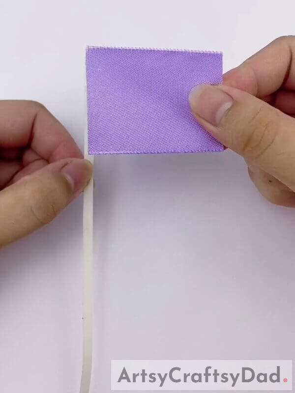 Stick Double-Sided Tape on the Edge of the Ribbon - Learn how to create a Purple Ribbon Pampas Decoration