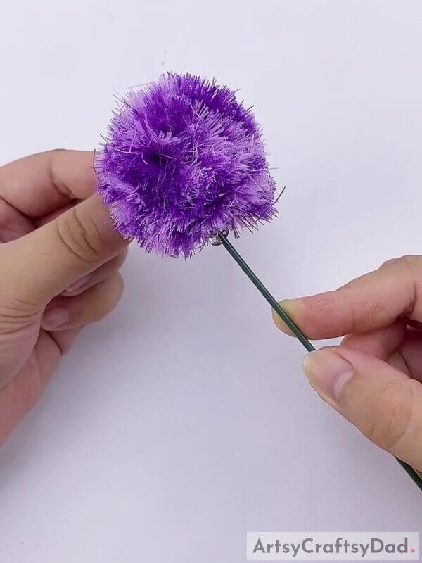 Stick the stick to the pom pom - Showing Kids How to Make Pom-Pom Flowers with Ribbons