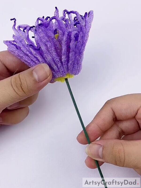 Take a dark green colored straw that will act as a stem - Crafting tutorial using netting and purple fruits 
