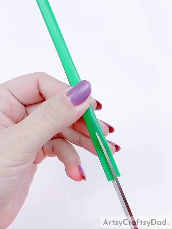 Take a light green plastic straw and a pair of scissors - Making a Plastic Straw and Lavender Blossom