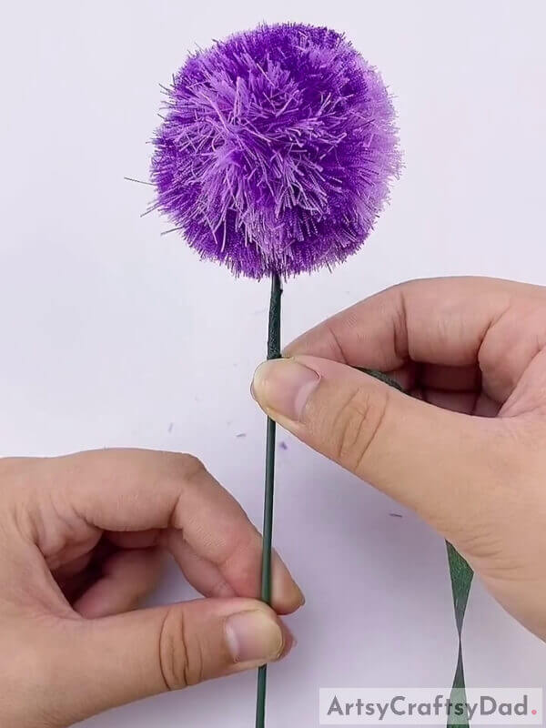 Wrap it using a glue - How To Guide Youngsters Through Creating A Ribbon Pom-Pom Flower