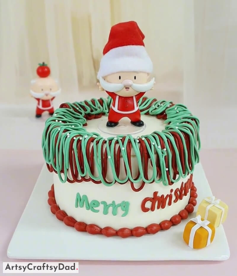 Artificial Santa Claus Topper Cake Decoration Idea for Christmas - Festive Cake Decoration Featuring a Tree and Snowman Topper