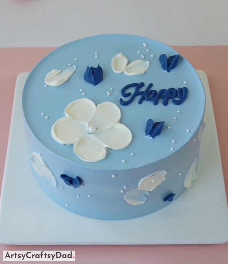 Beautiful White Flower and Pearl Decoration on Blue Cake - Light magenta buttercream flowers as a cake design for birthdays