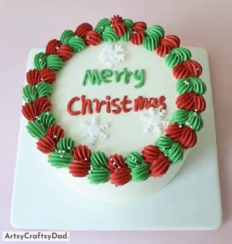 Buttercream White Snowflakes and Merry Christmas Written Topper - Cake Design - Creative Christmas Cake Decoration with a Tree and Snowman Topper