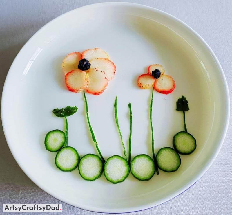 Flower Made out of Cucumber and Strawberry - Food Art on Plate - Appetizing Dishes Showcased on a White Plate