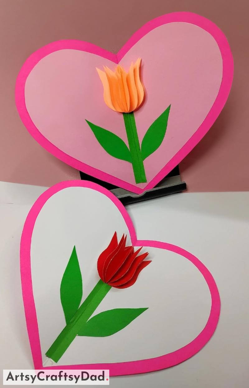 Folding Paper Flower Craft Activity On Heart Shaped Card Crafting paper flowers onto a heart-shaped card.