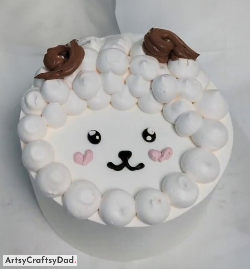 Handmade Sheep Face Cake Decoration Using Vanilla & Chocolate Cream - Children's Birthday Cake Decoration Ideas With An Animal Theme
