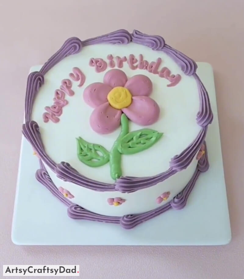 Pink Flower With Stem and Leaves - Simple Birthday Cake Decoration - Brighten up someone's birthday with a light magenta buttercream flower cake