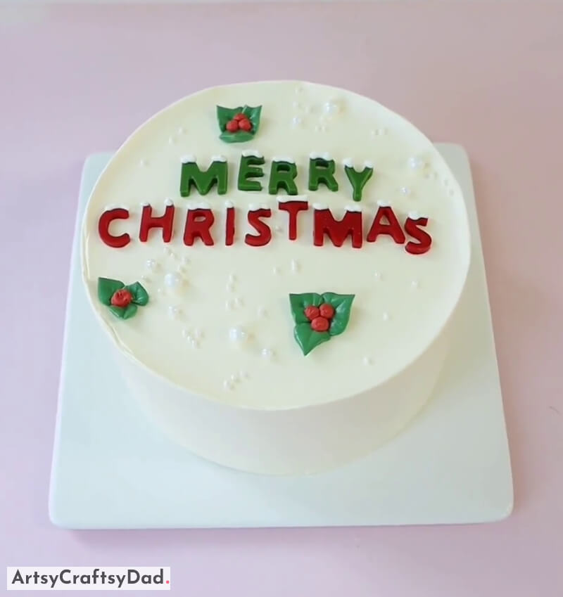 Simple Merry Christmas Cake Decoration Idea With Pearls - A Unique Cake Decoration Featuring a Christmas Tree and Snowman Topper