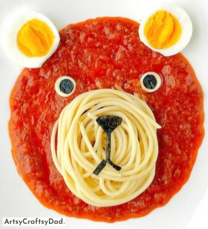 Spaghetti, Red Sauce, and Boiled Egg Bear Plate Decoration - A Visual Arrangement of Spaghetti, Tomato Sauce, and a Hard Cooked Egg