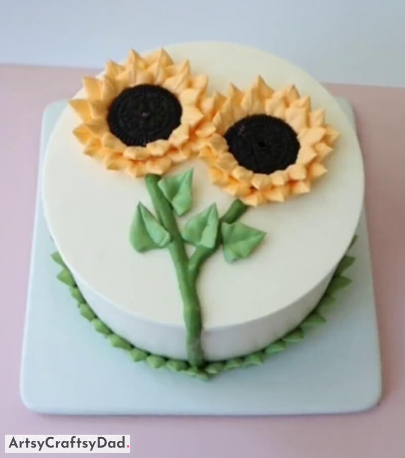 Two Sunflower Toppers with Leaves Decoration Idea On White Sponge Cake - Strategies for Decorating Cakes with a Sunflower Theme