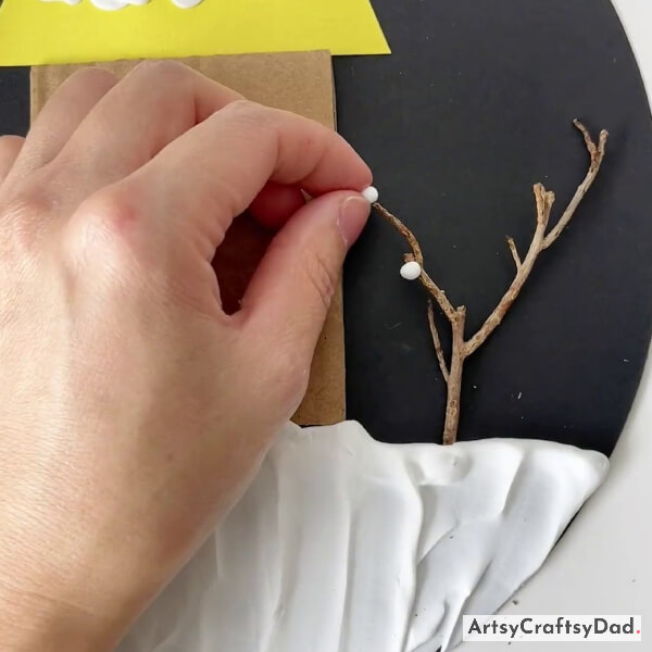 Pasting Small Clay Balls On The Twig
