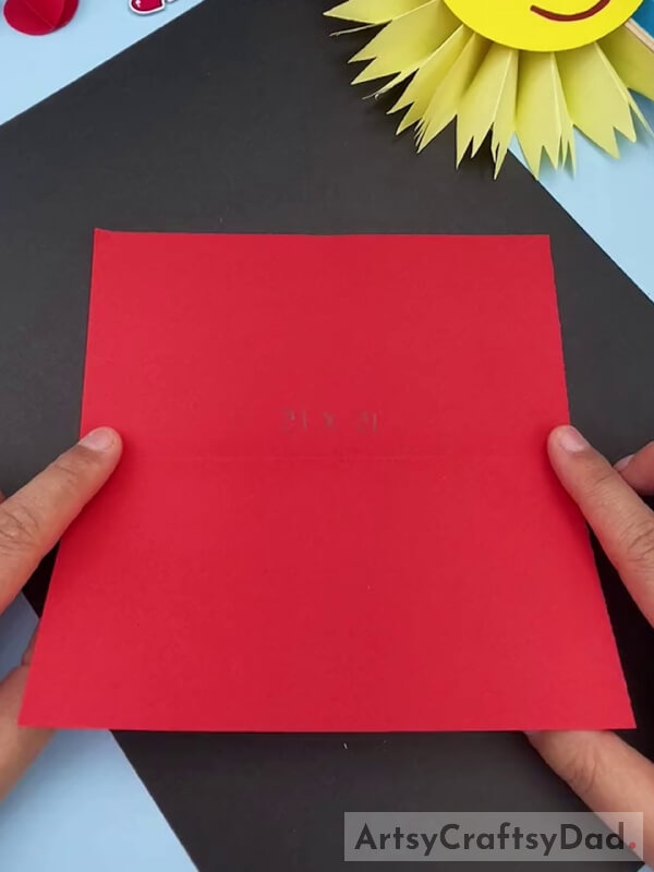 Folding a Red Sheet Paper