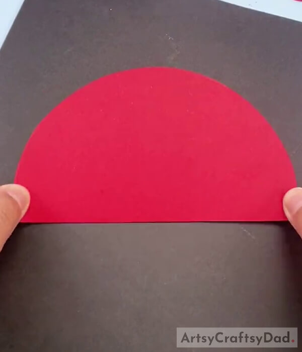 Taking a Semi-Circle Shape Red Paper
