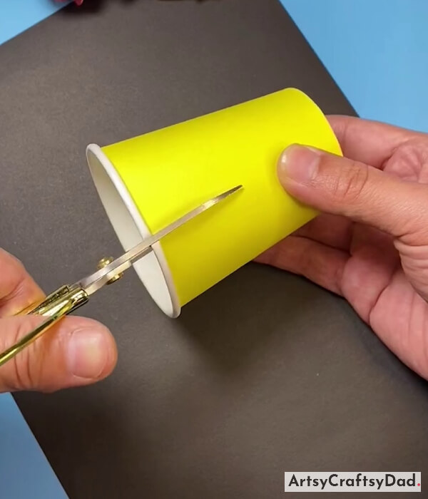 Taking A Yellow Color Paper Cup