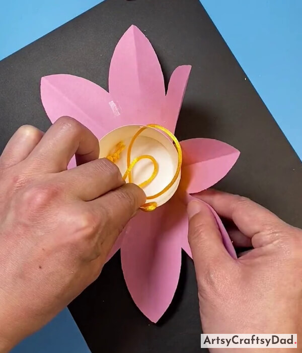 Putting Paper Cup At Center Of Pink Flower