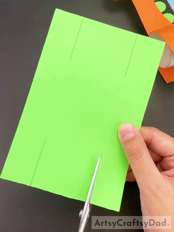 Cutting Side Lines Of Green Paper
