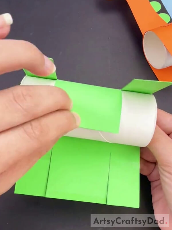 Rolling And Pasting Green Paper On Paper Roll